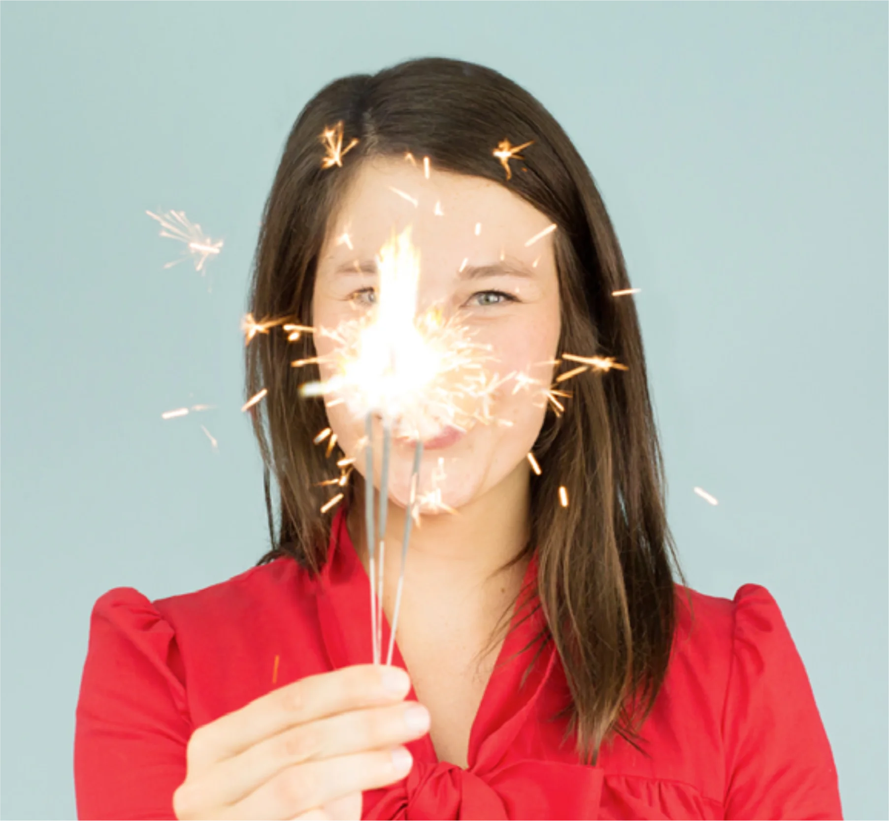 DaWanda creative team portrait holding sparklers against a mint background.