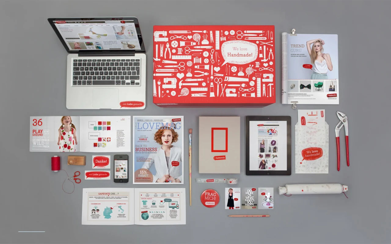 DaWanda brand identity across the website, packaging, LOVEMAG, stationery, mobile screens and merchandise.