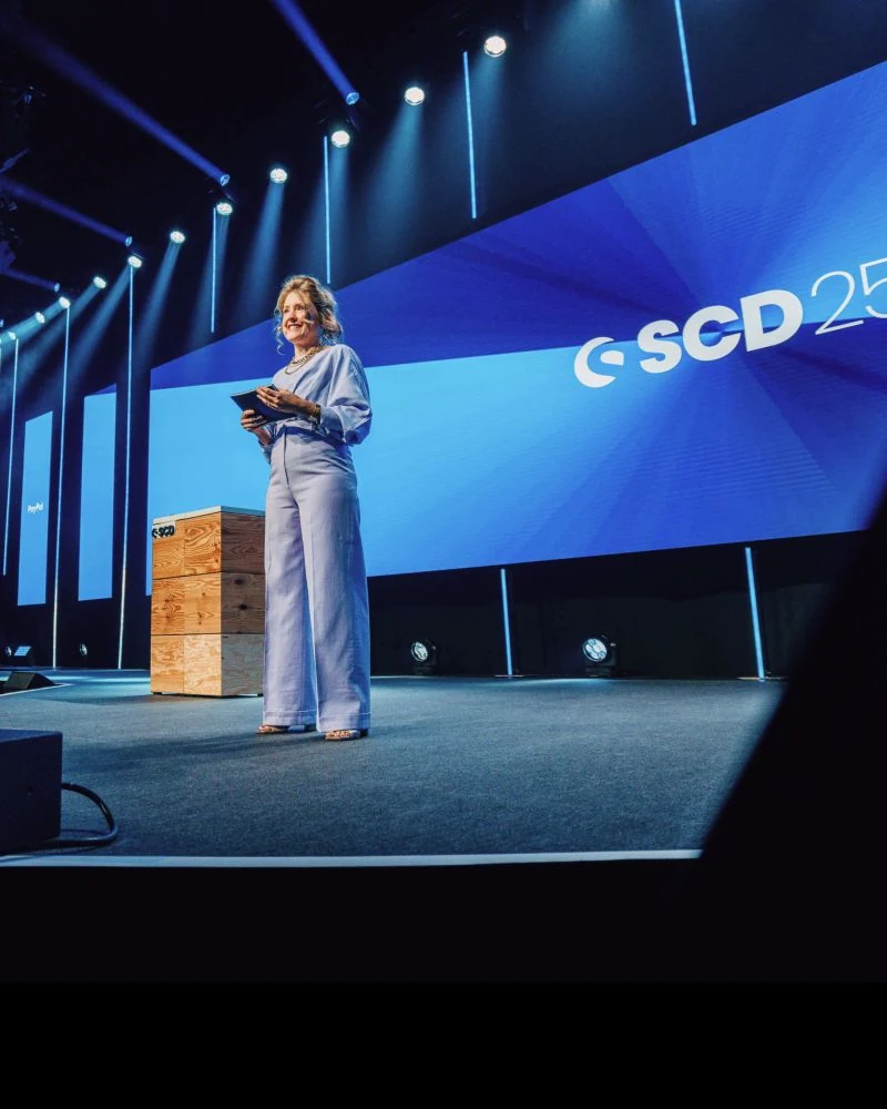 Shopware Community Day main-stage branding during a presentation.