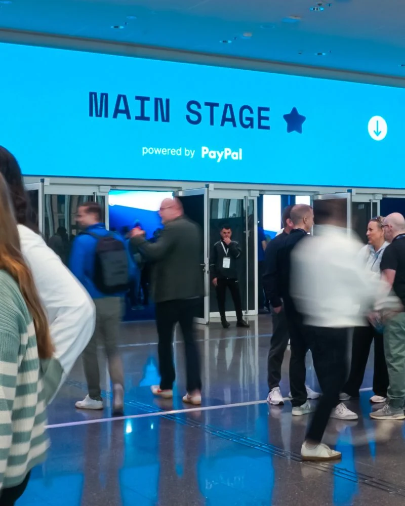 Main Stage wayfinding and event signage at Shopware Community Day 2025.
