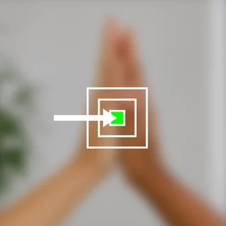 An arrow reaching a green target inside nested squares, over two hands meeting.
